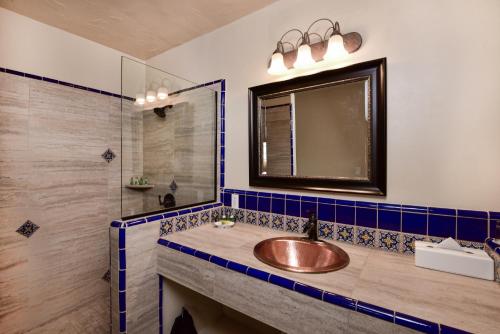 a bathroom with a sink and a mirror at Lodge On The Desert in Tucson