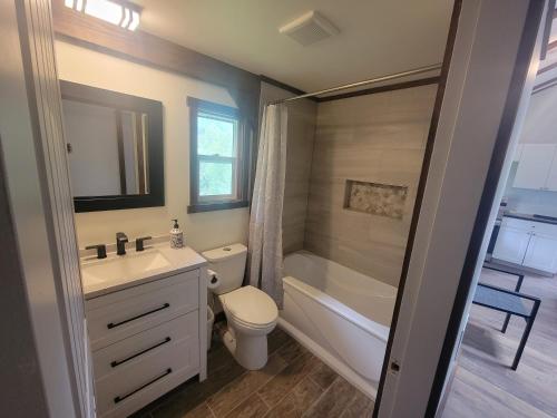 a bathroom with a sink and a toilet and a shower at Noah's Ark Campground in Revelstoke
