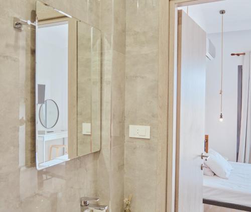 a bathroom with a shower with a mirror and a bed at Zanteapts 360 Gouzeli Apartment in Zakynthos Town