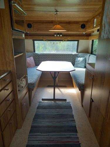 a table in the middle of a tiny house at Caravan at Solberg Hults Camping in Ekshärad