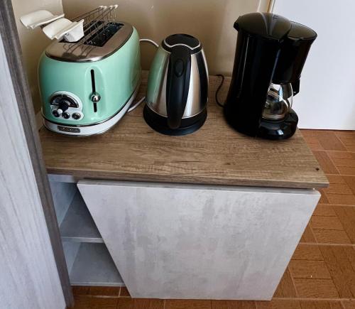 a counter with two coffee makers and a toaster on it at La bettola di cremia in Cremia