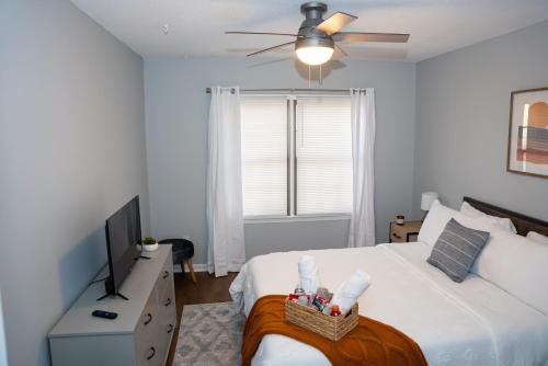 a white bedroom with a bed and a television at Luxury 3BR Townhome in the Heart of Winston Salem NC - Sleep 6 in Winston-Salem