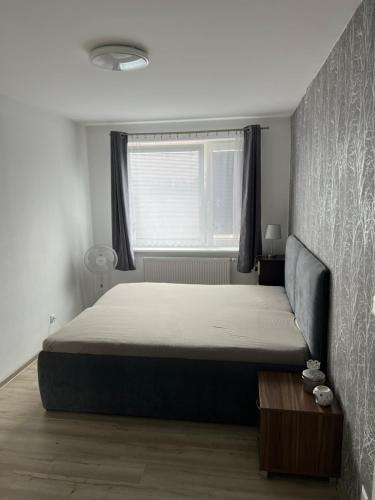 a bedroom with a bed and a window at Beautiful 2 Bedroom Apartment in Prostějov