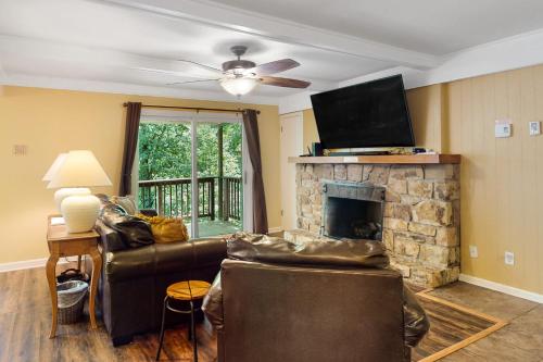 a living room with a couch and a fireplace at Casa Bee Branch in Sugar Mountain