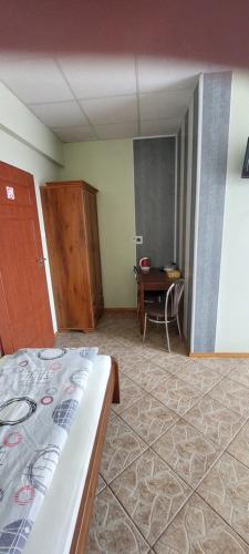 a bedroom with a bed and a desk and a table at Pokoje Gościnne HEVEN in Płock