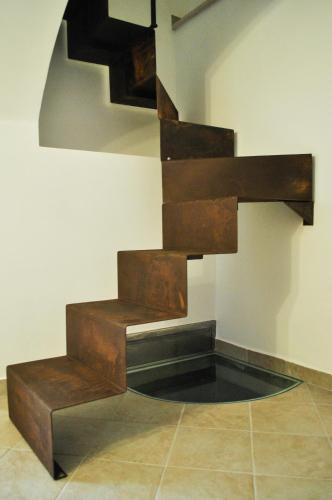 a set of wooden stairs on a wall at B&B LuiRò in Castellaneta
