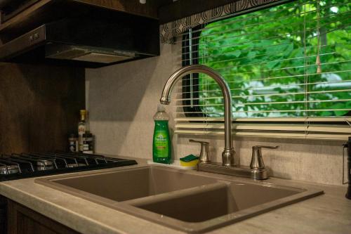 a sink in a kitchen with a window at Grotto Getaway in Miller Lake