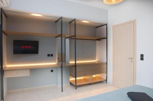 a bedroom with a closet with a tv in it at Philippos & Alexandros Apartments in Tigaki