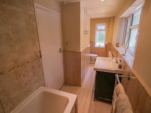 bagno con vasca, lavandino e doccia di Primrose Spinney a Ringwood