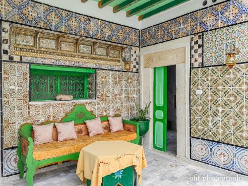 a living room with a couch and a table at Dar Badiaa in Sousse