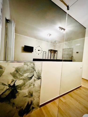 a room with a table and a clock on the wall at Akropoli Exclusive Room in Agrigento