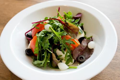 a white bowl of salad with meat and vegetables at Pensjonat pod Samowarem in Tylicz