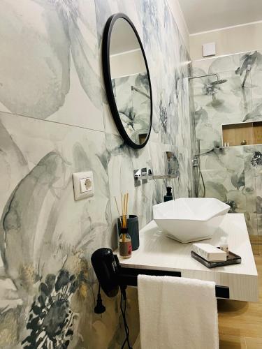 a bathroom with a sink and a mirror at Akropoli Exclusive Room in Agrigento