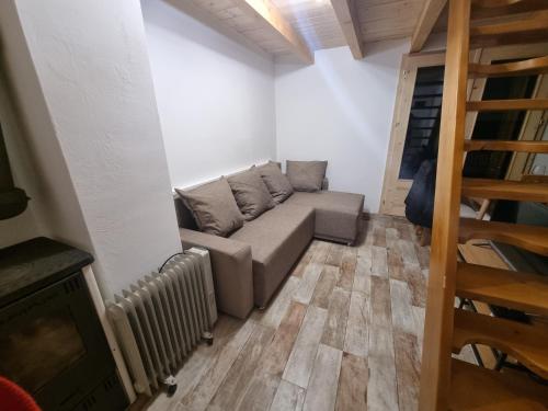 a living room with a couch and a radiator at Etno Zvuk Tisine Djukic in Valjevo