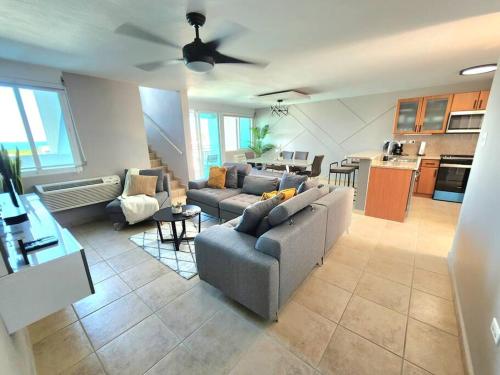 a large living room with couches and a kitchen at Hillside Village Retreat in Rio Grande