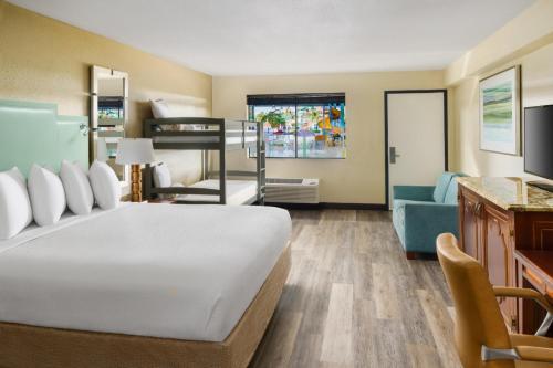 a bedroom with a bed and a living room at Coco Key Hotel & Water Park Resort in Orlando