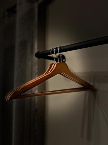 a wooden hanger in a room with a curtain at Akropoli Exclusive Room in Agrigento