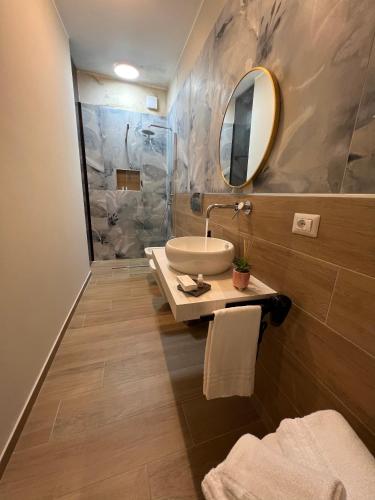 a bathroom with a sink and a mirror at Akropoli Exclusive Room in Agrigento