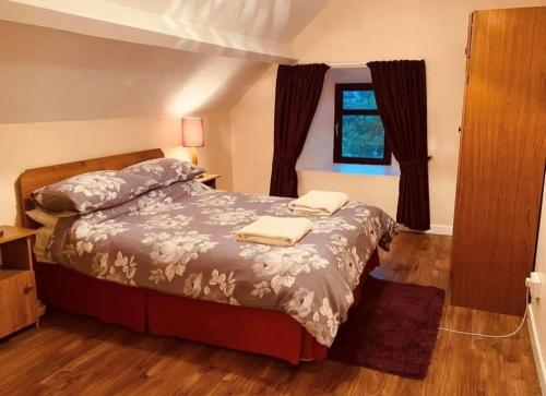 a bedroom with a bed with two towels on it at Reelin bar holiday Accommodation in Cloghan