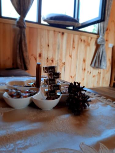 a table with two bowls of food on it at Wooden cottage Podgora in Žabljak
