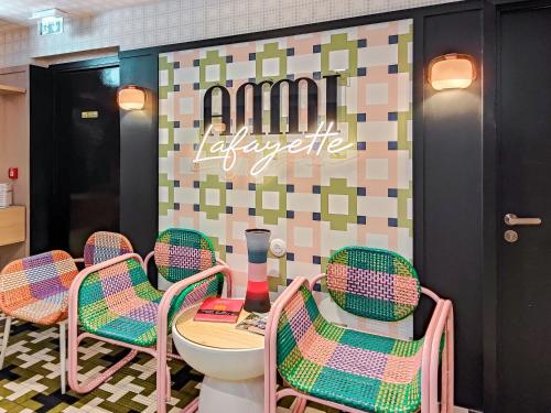 a restaurant with chairs and a table and a toilet at Aparthotel AMMI Nice Lafayette in Nice