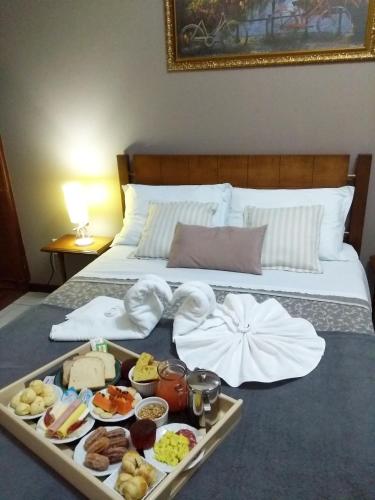 a tray of food sitting on top of a bed at Pousada Canasvieiras in Florianópolis