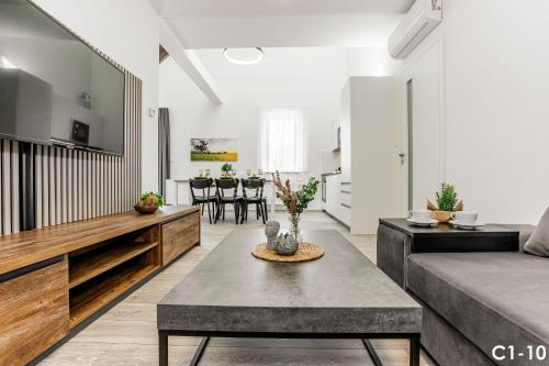 a living room with a couch and a table at KORZO LIPNO C in Lipno nad Vltavou