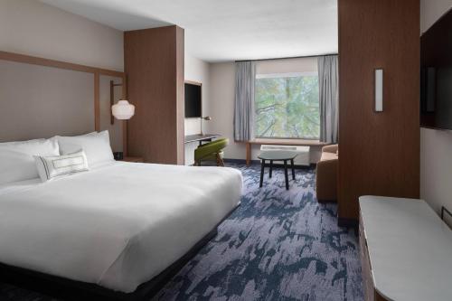 a hotel room with a large bed and a desk at Fairfield Inn & Suites by Marriott Kenosha Pleasant Prairie in Pleasant Prairie