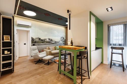 a living room with a green table and a couch at Rosetti One in Constanţa