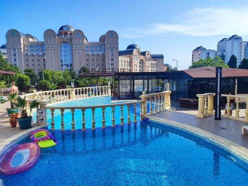 a swimming pool in a city with a building at Комплекс Виста Дел Мар 2, студио in Sunny Beach