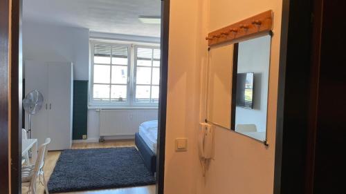 a room with a bedroom with a bed and a mirror at Linz -central condo in Linz