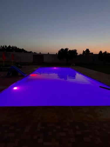 a blue swimming pool with lights on it at AYOR FES in El Oulaij