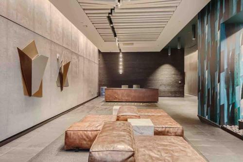 a lobby with brown leather couches in a room at Downtown Austin Oasis Luxurious Studio Retreat with amazing Pool and Gym in Austin