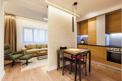 a kitchen and living room with a table and chairs at Rosetti One in Constanţa