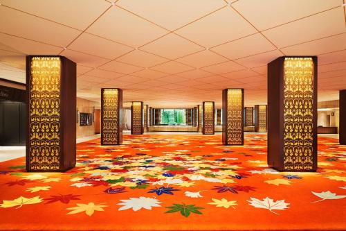 a lobby with an orange floor with leaves on it at RIHGA Royal Hotel Osaka in Osaka
