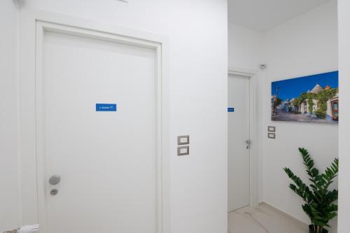 a room with white doors and a plant at B&B BISCEGLIE in Bisceglie