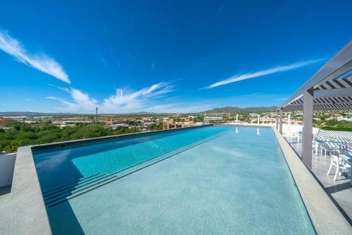 a swimming pool on the roof of a house at Casa Sueño - Modern, spacious & luxurious brand new condo in Cabo San Lucas