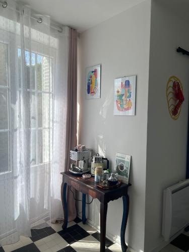 une petite table dans une pièce avec une fenêtre dans l'établissement Venez Vernou, à Marangis