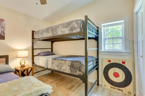 a bedroom with two bunk beds and a window at Secluded Poconos Cabin 75 Acres and Fire Pit! in East Stroudsburg