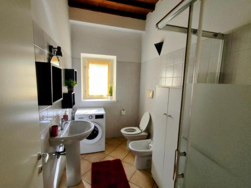 a bathroom with a sink and a toilet at Corte dei sogni - Mountain and Lake in Ranzanico