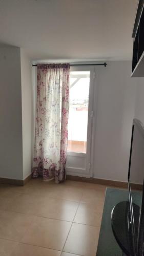 a living room with a window and a door at Apartamentos Centro El Rompido in El Rompido