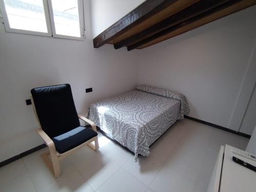 a bedroom with a bed and a chair at Estudio Centro - Puerta del Sol in Madrid
