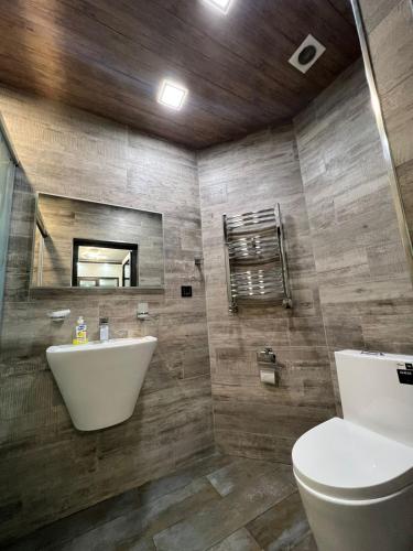 a bathroom with a sink and a toilet at DELUXE Modernly Renovated 2 Bedroom + 2 Bathroom Apt by REPUBLIC SQUARE in Yerevan