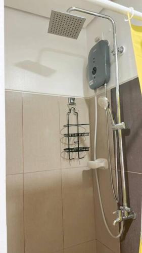 a shower in a bathroom with a cage on the wall at Night Blink Staycation and Rentals in Manila