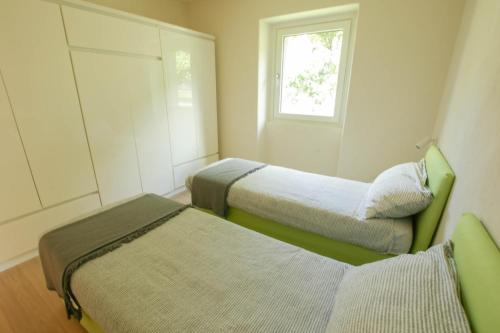 a room with two beds and a window at Style apartments VdA in Senin