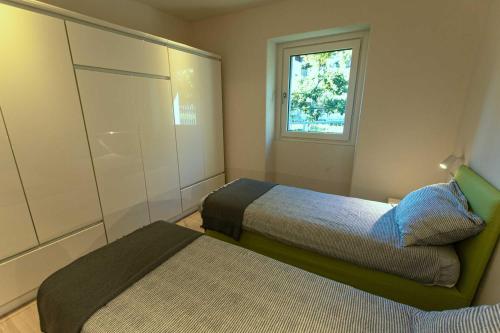 a bedroom with two beds and a window at Style apartments VdA in Senin