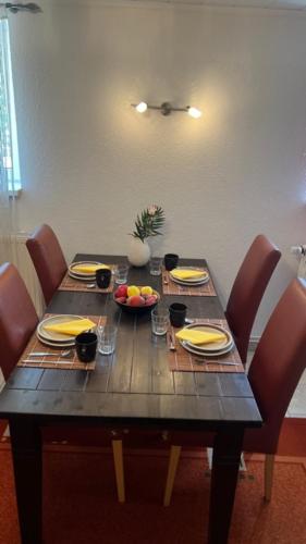 a wooden table with chairs and a table with food on it at Ferienwohnung-Schluecke in Bad Frankenhausen