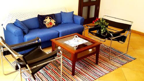 a living room with a blue couch and chairs at Palazzo Zimatore Residenza D'Epoca in Pizzo