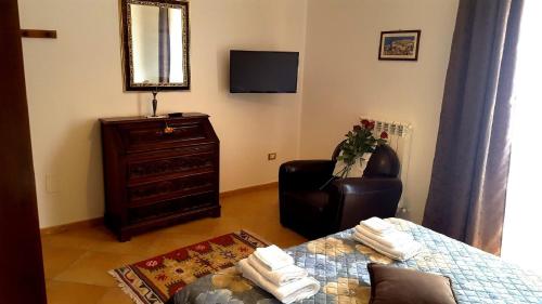 a living room with a couch and a chair at Palazzo Zimatore Residenza D'Epoca in Pizzo