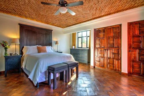 een slaapkamer met een bed en een plafondventilator bij Casa Trébol - San Miguel de Allende in San Miguel de Allende